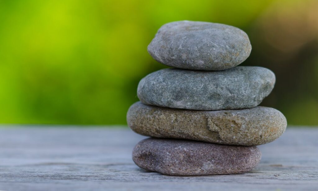 stones stacked on a path representing peacefulness and solidarity